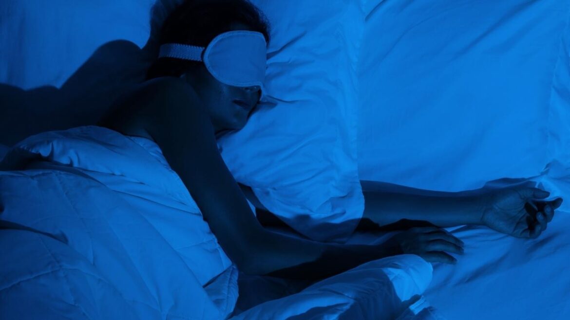 Person using smartphone in bed at night disrupting natural science of sleep patterns with blue light exposure
